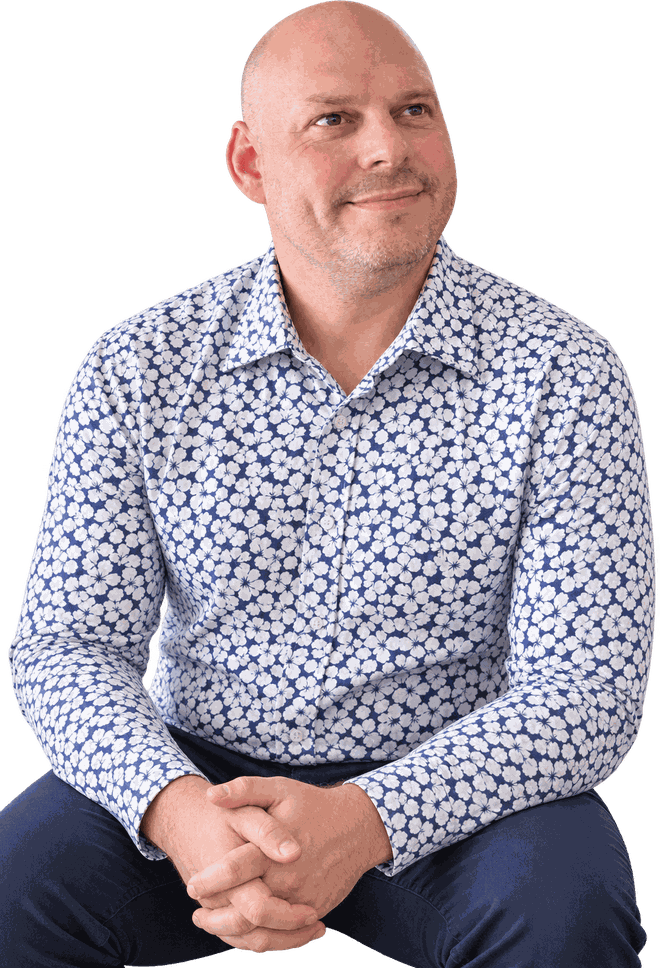 Leigh Hathaway, seated, wearing a blue and white floral shirt.